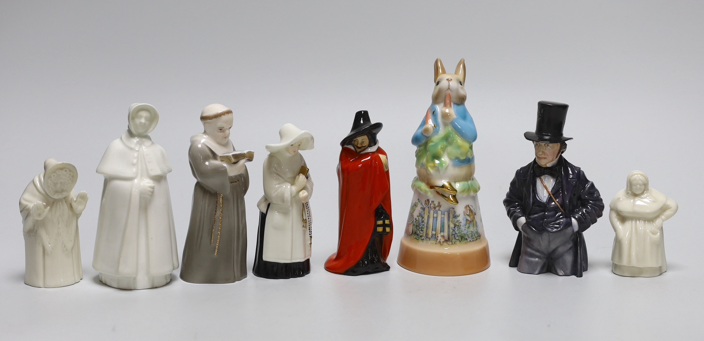 A collection of eight extinguishers including Worcester and Royal Doulton, the largest 13cm high
